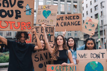 protesters with signs related to climate change