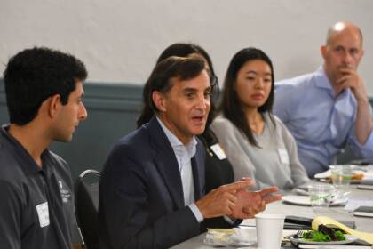 President Ronald J. Daniels at a table with staff